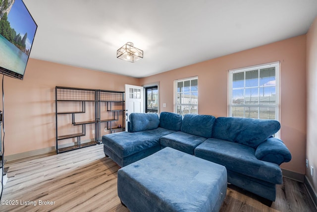 living room featuring wood finished floors and baseboards