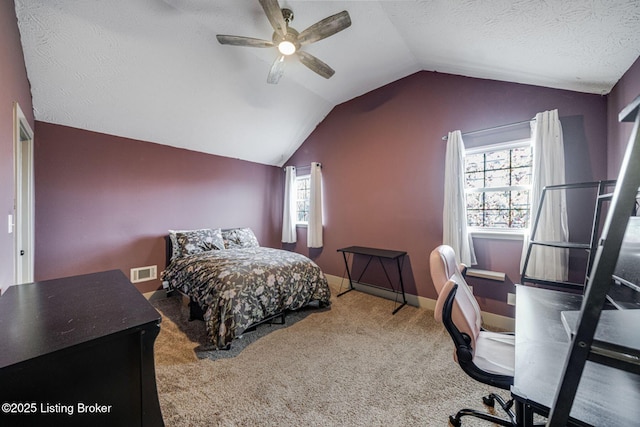 carpeted bedroom with visible vents, vaulted ceiling, a textured ceiling, and multiple windows