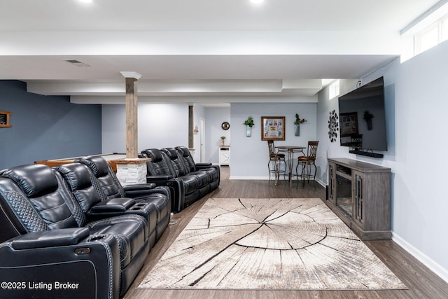 living area featuring dark wood-style floors, visible vents, and baseboards