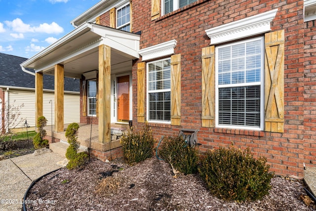 property entrance featuring brick siding