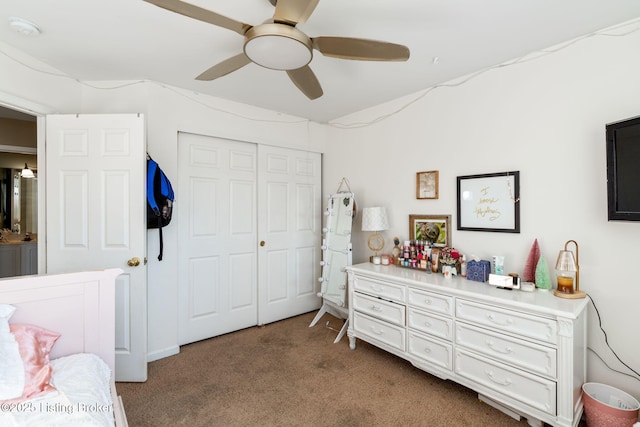 carpeted bedroom featuring ceiling fan and a closet