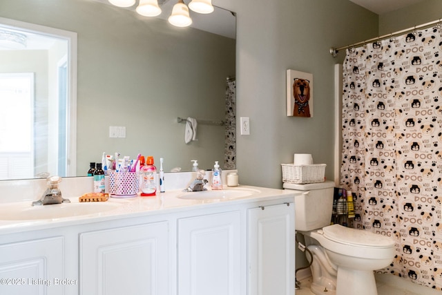 full bathroom with curtained shower, a sink, toilet, and double vanity