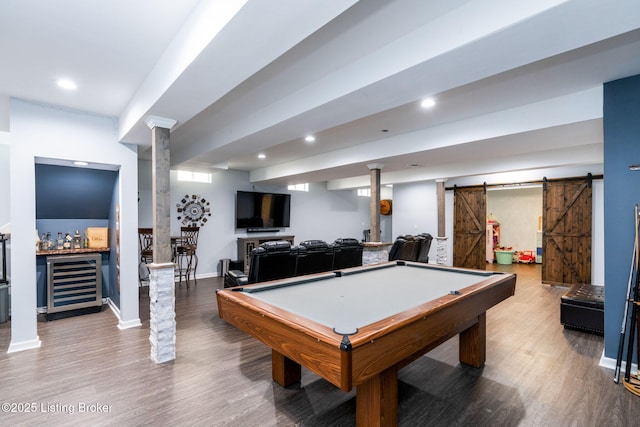 game room featuring wine cooler, wood finished floors, recessed lighting, and a barn door