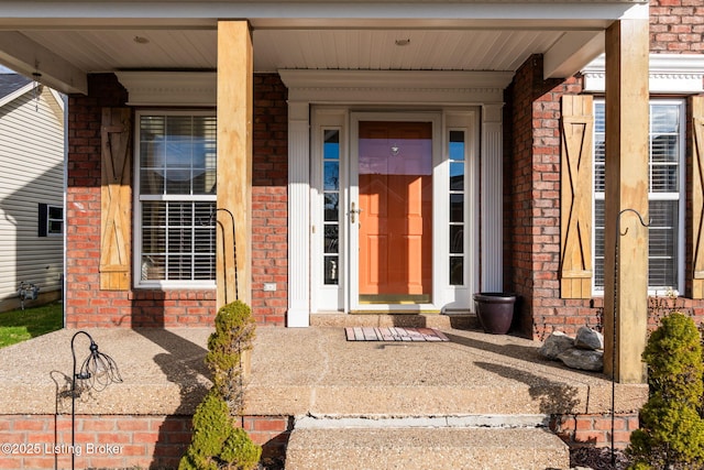 doorway to property featuring brick siding