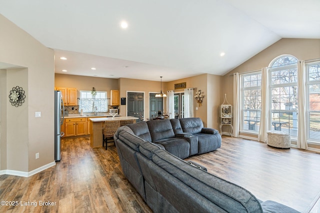 living area with dark wood-style floors, baseboards, vaulted ceiling, and recessed lighting