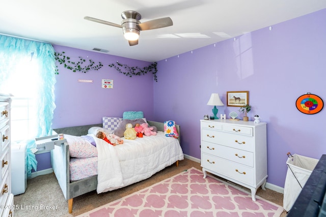 bedroom featuring light carpet, ceiling fan, visible vents, and baseboards