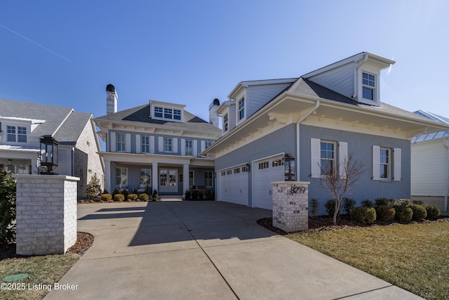 view of front of property featuring driveway, a garage, and brick siding