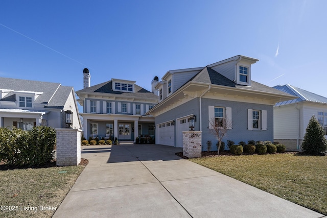 view of front facade with an attached garage, a front lawn, concrete driveway, and brick siding