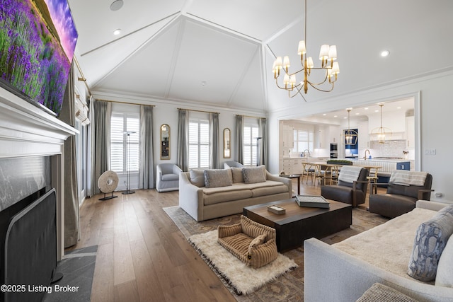 8219 Sutherland Farm Rd, Prospect, KY 40059 - living room featuring high vaulted ceiling, recessed lighting, a notable chandelier, a fireplace with flush hearth, and wood-type flooring