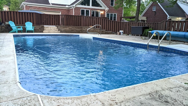 view of swimming pool with fence and a fenced in pool