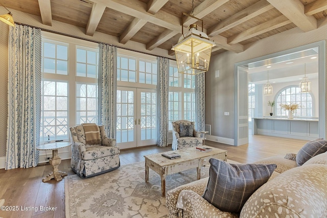 living area featuring wood ceiling, wood-type flooring, and french doors