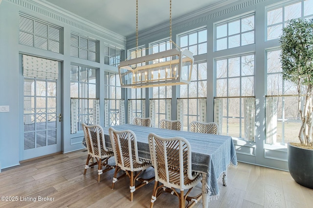 sunroom featuring an inviting chandelier