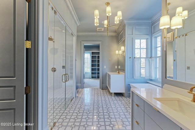 full bath with a stall shower, plenty of natural light, ornamental molding, and a sink