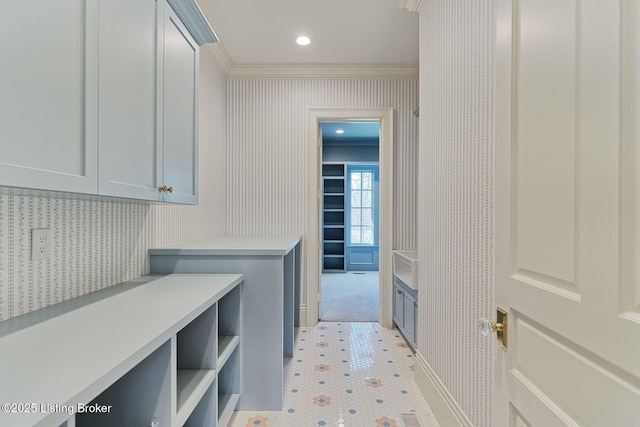 interior space featuring wallpapered walls, crown molding, and recessed lighting