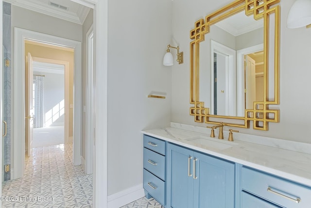 bathroom with ornamental molding, vanity, visible vents, and baseboards