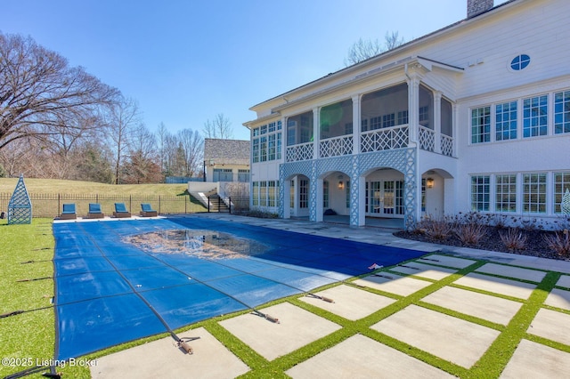 view of swimming pool featuring a fenced in pool, a sunroom, fence, french doors, and a patio area