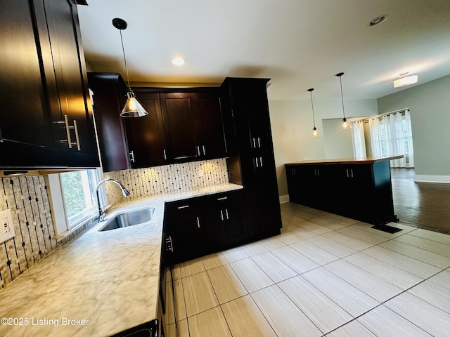 438 S Hite Ave, Louisville, KY 40206 - kitchen featuring decorative backsplash, pendant lighting, light tile patterned flooring, light stone countertops, and recessed lighting