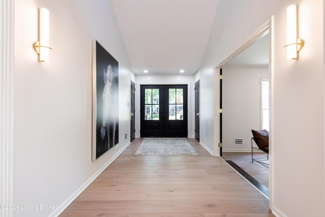 entrance foyer featuring visible vents, baseboards, french doors, light wood-style floors, and recessed lighting