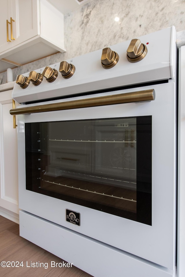 interior details featuring white cabinetry, dark wood finished floors, and light countertops