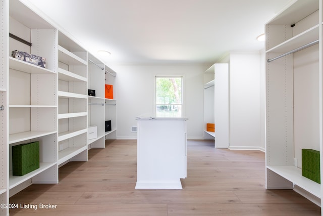 spacious closet featuring light wood-style flooring and visible vents