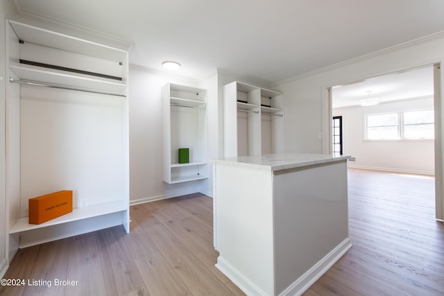 walk in closet with light wood-type flooring