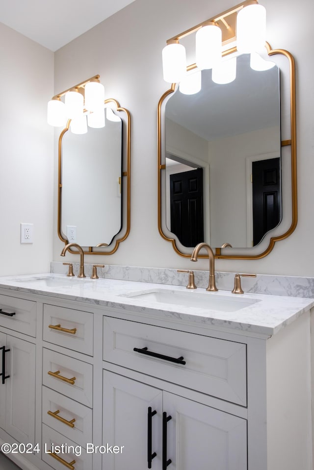 bathroom featuring a sink and double vanity