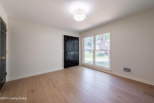 entryway with light wood-style floors, visible vents, and baseboards