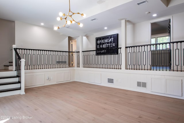 unfurnished room featuring light wood-style flooring, visible vents, a notable chandelier, and recessed lighting