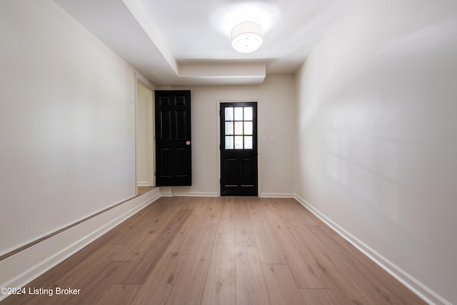 foyer featuring light wood-style floors and baseboards