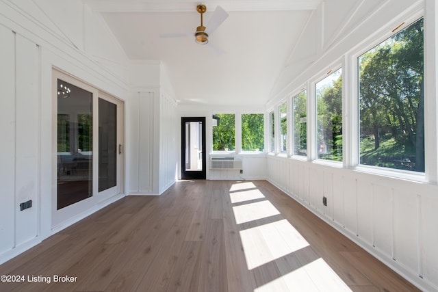 unfurnished sunroom with lofted ceiling, ceiling fan, and a wall mounted AC