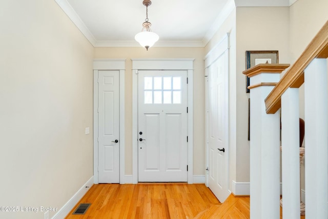 entryway featuring light wood-style flooring, visible vents, baseboards, stairs, and ornamental molding