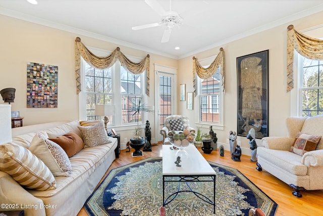 living room with recessed lighting, wood finished floors, a ceiling fan, baseboards, and crown molding