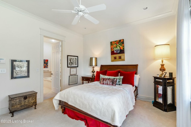 bedroom featuring light carpet, ensuite bath, and crown molding