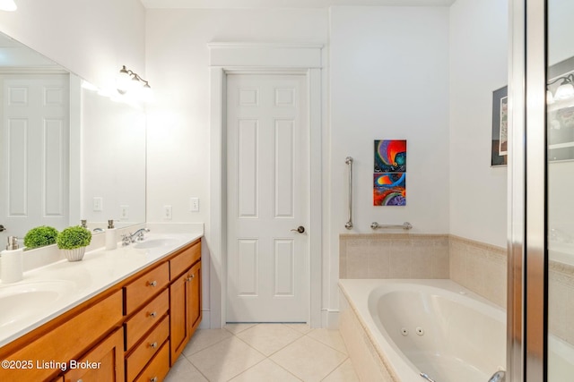 full bath with double vanity, a tub with jets, a sink, and tile patterned floors