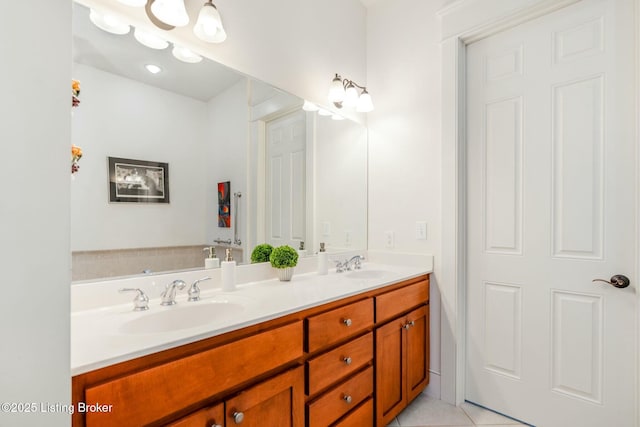 full bathroom featuring double vanity, a sink, and tile patterned floors