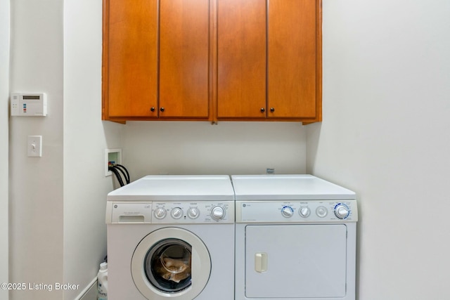 laundry room featuring cabinet space and washing machine and clothes dryer