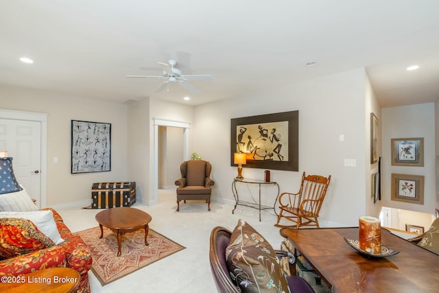 living area featuring baseboards, recessed lighting, a ceiling fan, and light colored carpet