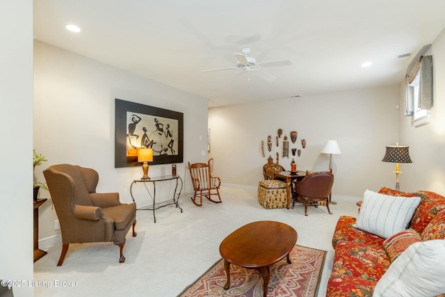 living area with recessed lighting, light colored carpet, visible vents, and baseboards