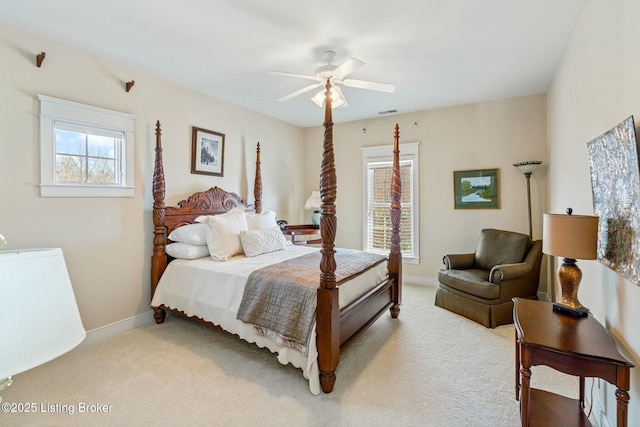 bedroom featuring a ceiling fan, light colored carpet, visible vents, and baseboards