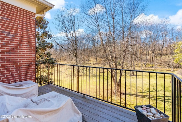 wooden deck featuring a yard