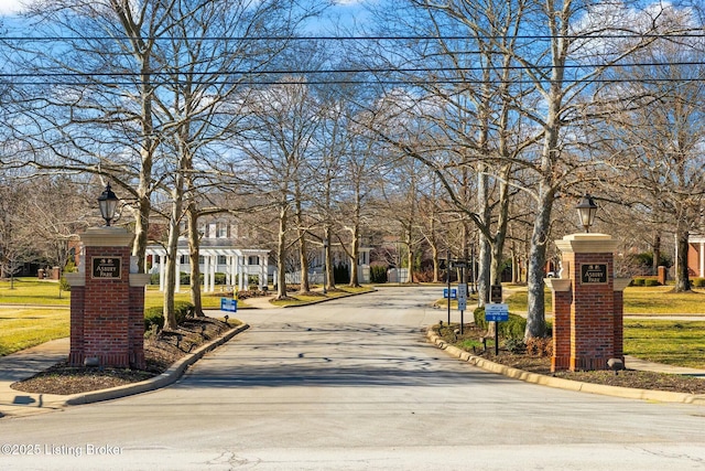 view of road featuring street lighting, curbs, and sidewalks