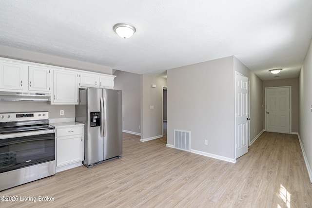 kitchen featuring under cabinet range hood, white cabinetry, visible vents, light countertops, and appliances with stainless steel finishes