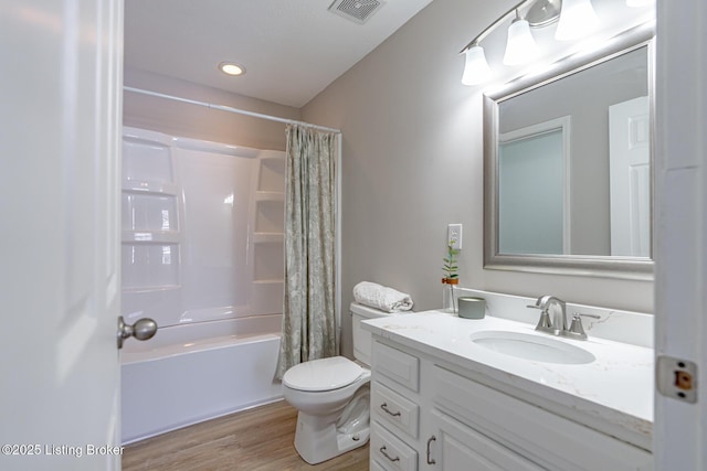 bathroom featuring shower / tub combo with curtain, visible vents, toilet, vanity, and wood finished floors