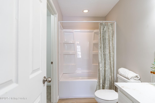 bathroom featuring toilet, recessed lighting, wood finished floors, vanity, and shower / bath combo with shower curtain