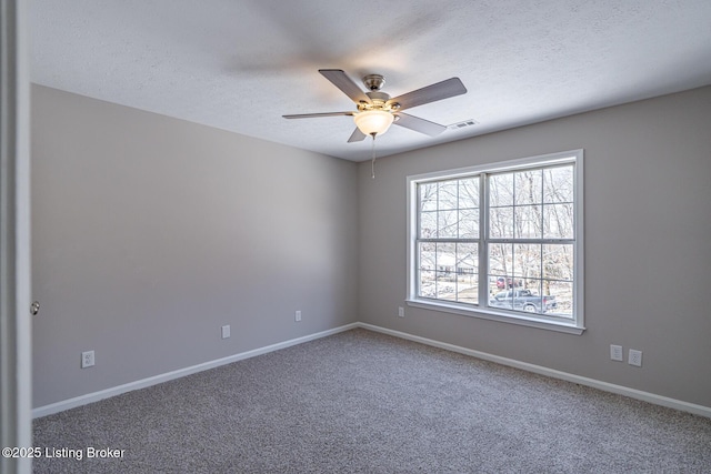 unfurnished room featuring visible vents, baseboards, a ceiling fan, a textured ceiling, and carpet flooring