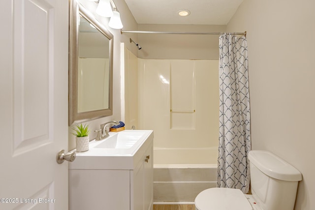 full bath with toilet, shower / bath combo with shower curtain, and vanity