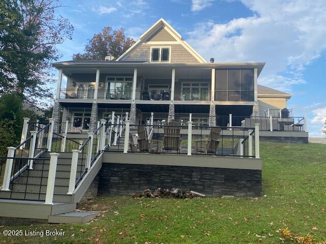 back of property featuring stairs and a yard