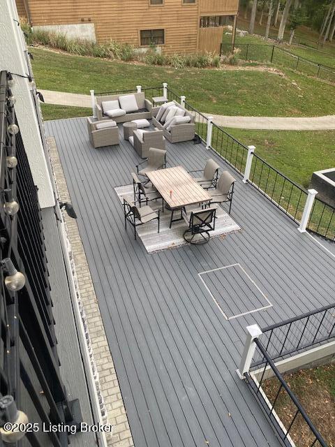 deck featuring outdoor dining space, outdoor lounge area, a yard, and fence