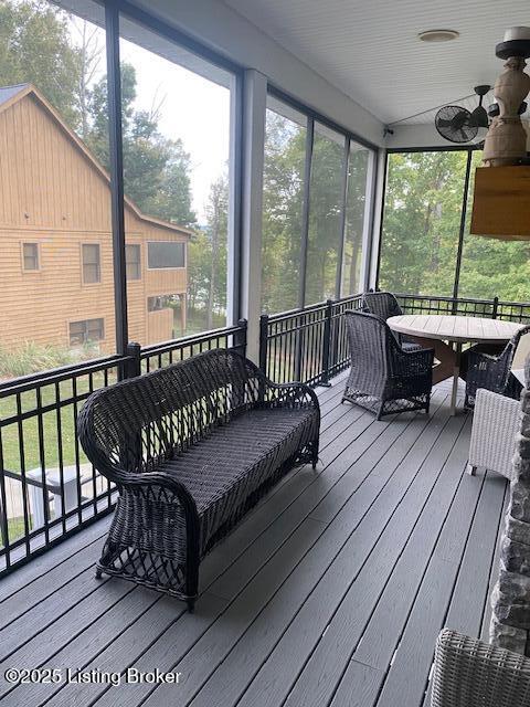 sunroom / solarium with a ceiling fan