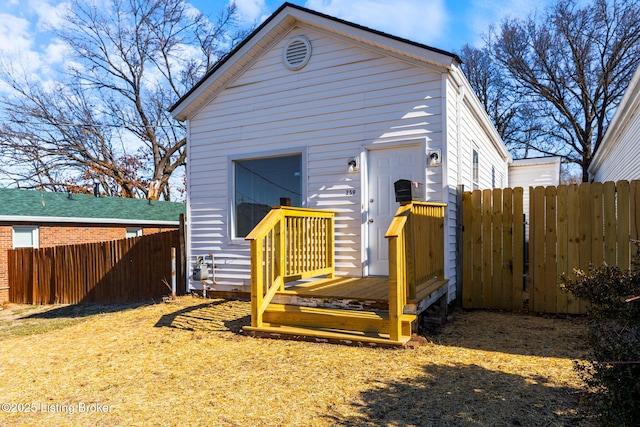 view of outbuilding featuring fence